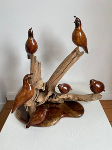 Large sculpture of six redwood burl quail perched on dripwood and a base of inlaid, figured woods